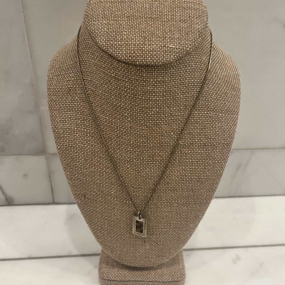 Tortoise shell pendant necklace and earrings.